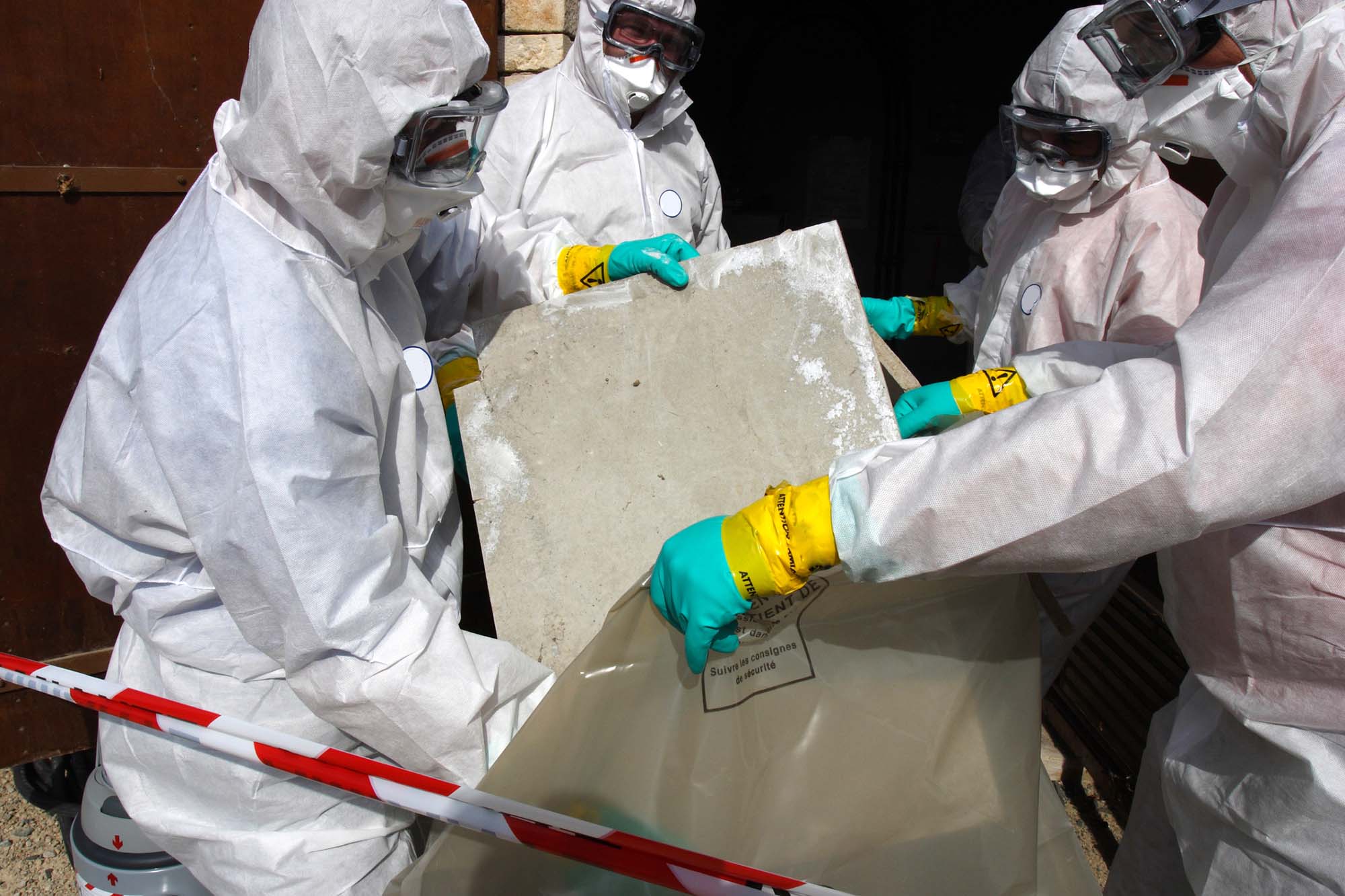 Dangerous work. Staff removing some asbestos in a post of transformer